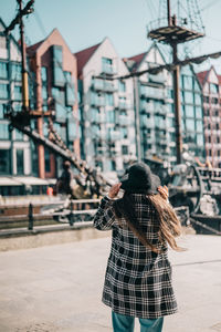 Rear view of woman walking on street