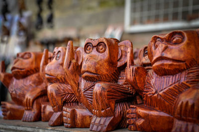 Close-up of wooden statues for sale in market