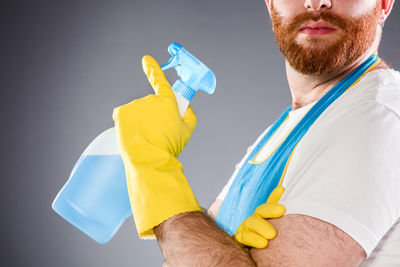 Midsection of man holding umbrella
