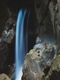 Low angle view of waterfall in forest