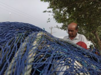 Full length of man fishing net