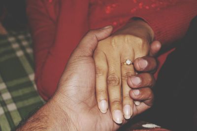 Close-up of couple holding hands