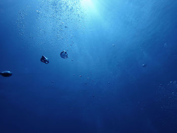 Close-up of bubbles against blue sea