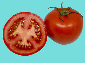 Close-up of red apple against blue background