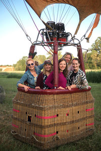 Portrait of friends standing in hot air balloon