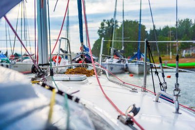 Sailboats moored in water against sky