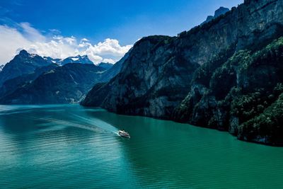 Scenic view of mountains against blue sky