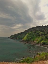 Scenic view of sea and mountains against sky