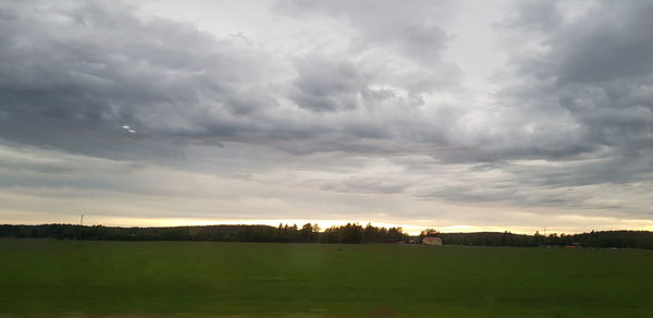 Scenic view of field against sky during sunset