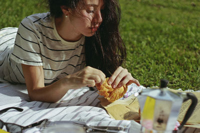 Midsection of woman sitting outdoors