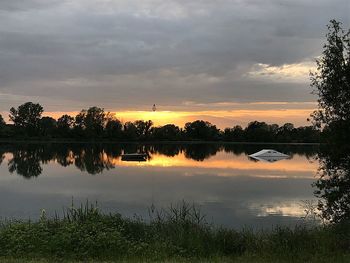 Scenic view of lake against sky during sunset