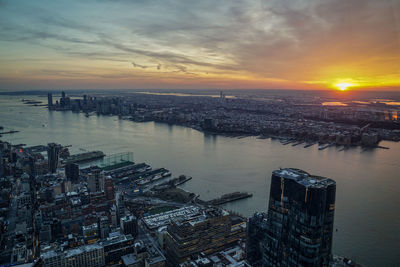 High angle view of illuminated cityscape against sky during sunset