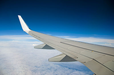 Airplane wing against sky