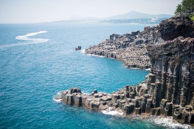 Scenic view of sea by town against sky