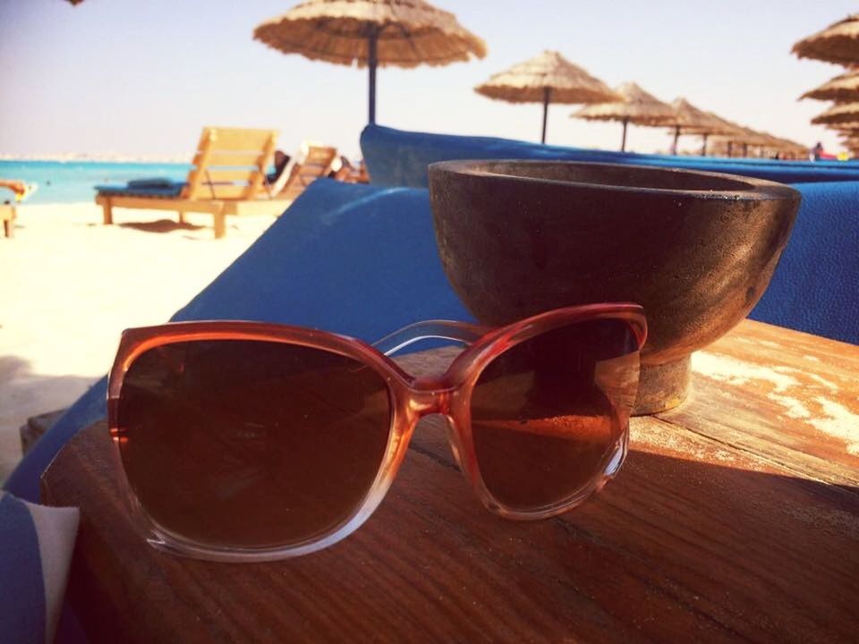 CLOSE-UP OF SUNGLASSES ON TABLE