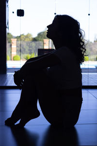 Low angle view of woman sitting on floor