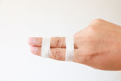 Close-up of hand against white background