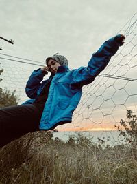 Rear view of woman standing on field