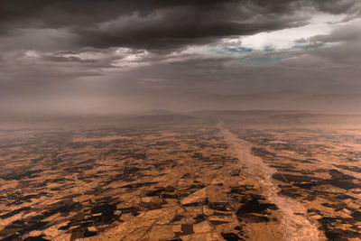 Aerial view of landscape against cloudy sky