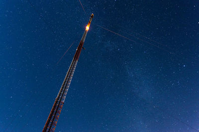 Low angle view of vapor trails against clear blue sky