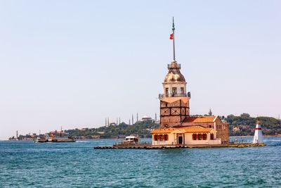 View of building by sea against sky