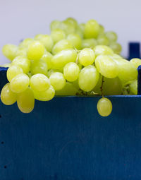 Green grapes in a blue wooden box