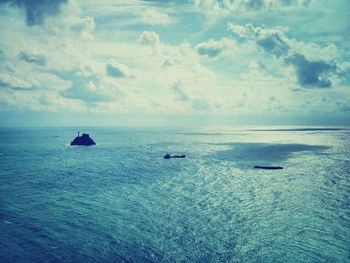 Scenic view of sea against cloudy sky