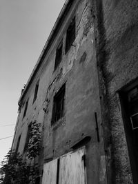 Low angle view of abandoned building against sky