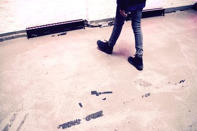 Low section of woman standing on tiled floor