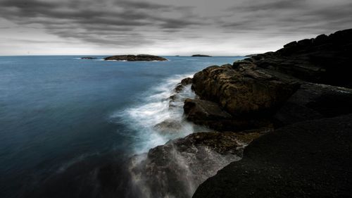 Scenic view of sea against cloudy sky
