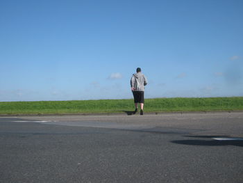 Full length of woman walking on road