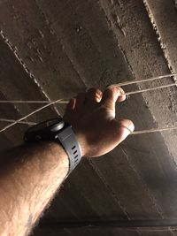 High angle view of person hand on wall