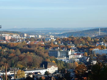 High angle view of cityscape by sea against sky