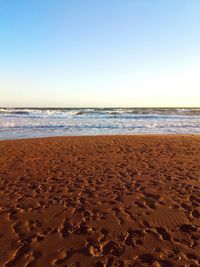 Scenic view of beach against clear sky