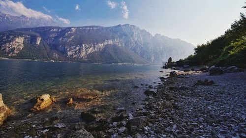 Scenic view of sea and mountains against sky