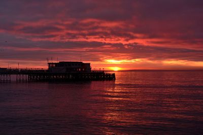 Scenic view of sea against dramatic sky during sunset