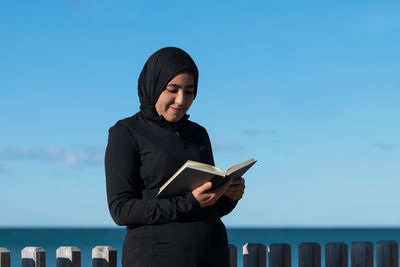 Portrait of young woman using mobile phone