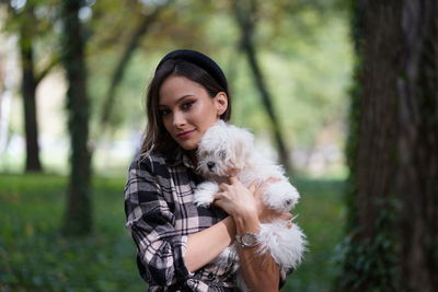 Portrait of young woman with dog