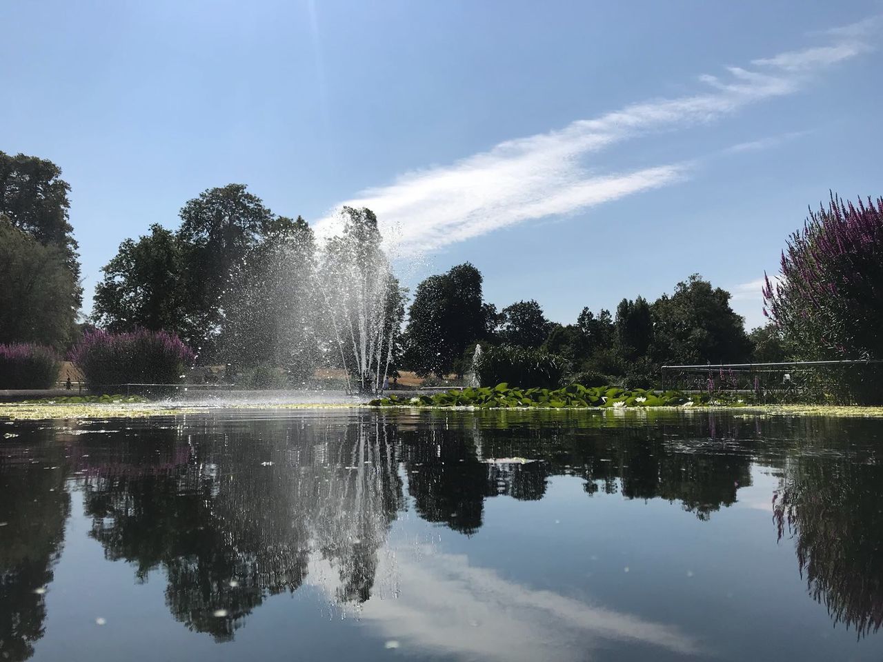 FOUNTAIN IN LAKE AGAINST SKY