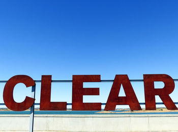 Low angle view of clear text against clear blue sky