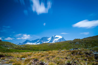 Scenic view of mountains against blue sky