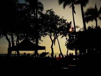 Silhouette palm trees at sunset