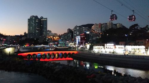 Illuminated city against clear sky