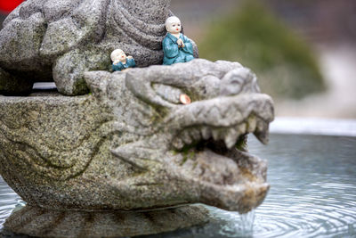 Figurines on sculpture in fountain
