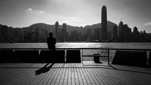 Silhouette man with cityscape in background