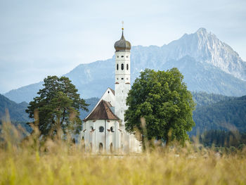 Castle by building against sky