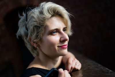 Young blonde woman smiling happy walking at the city