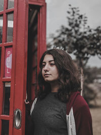 Portrait of young woman looking away outdoors