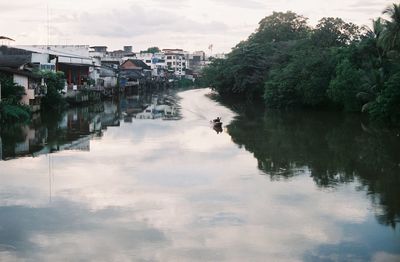 River amidst buildings against sky