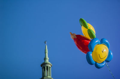 Low angle view of sculpture against clear blue sky